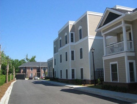 a row of white houses on the side of a street