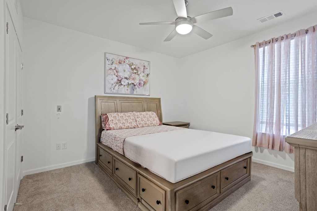 Ovata at Reedy Creek bedroom with ceiling fan and carpet.