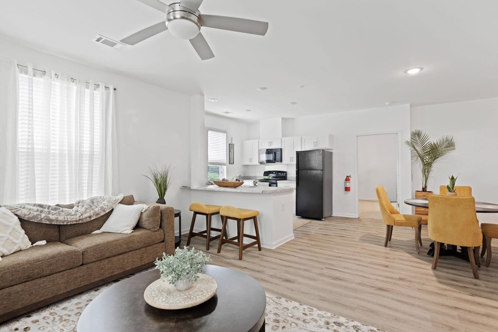 Ovata at Reedy Creek view of kitchen from living room. Both have luxury vinyl tile flooring and the kitchen has modern appliances.