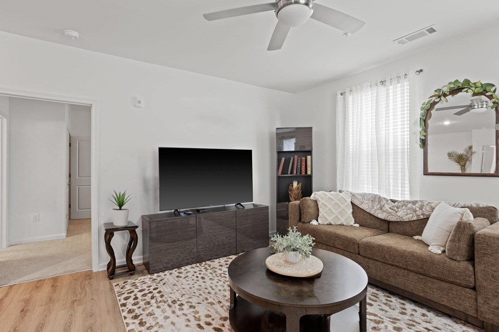 Ovata at Reedy Creek living room with luxury vinyl tile flooring and a ceiling fan