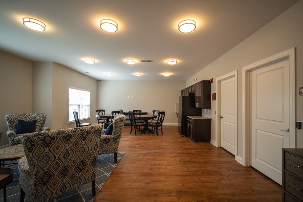 A living room with a patterned chair and a dining table.