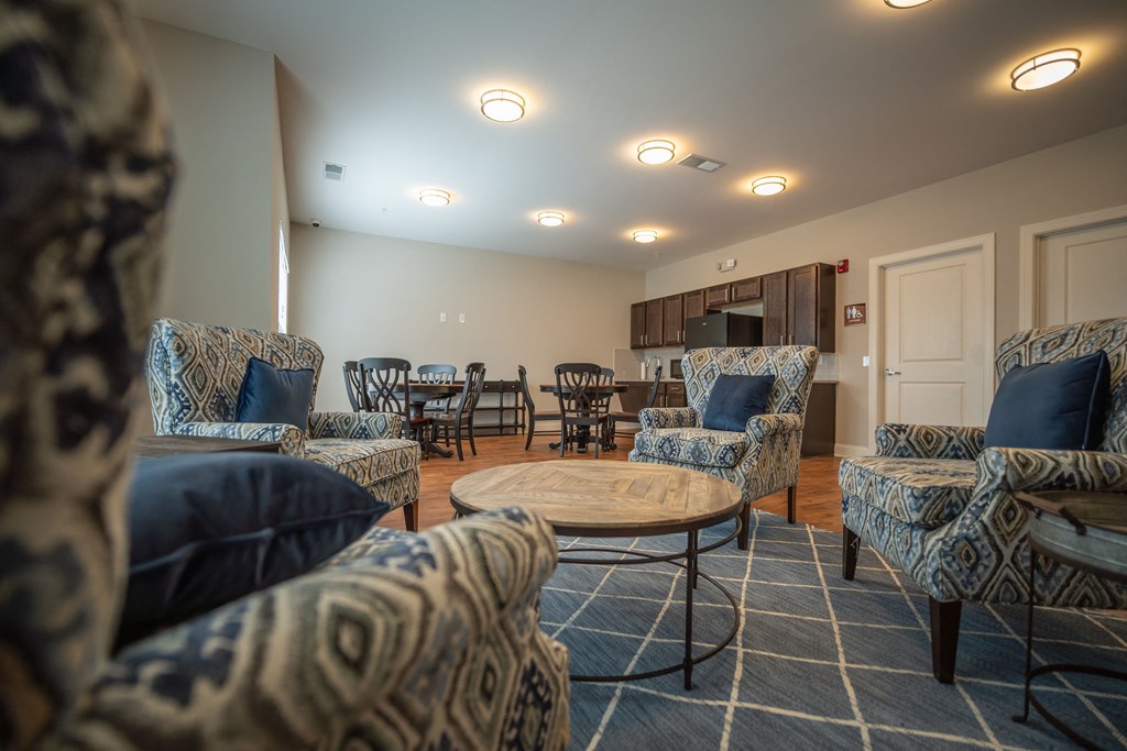 A living room with patterned chairs and a coffee table.