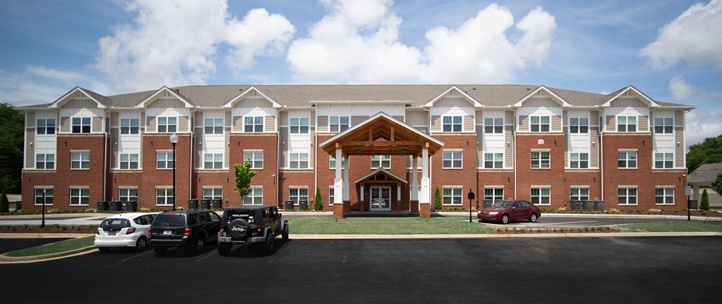 A large red and white building with a wooden entrance.
