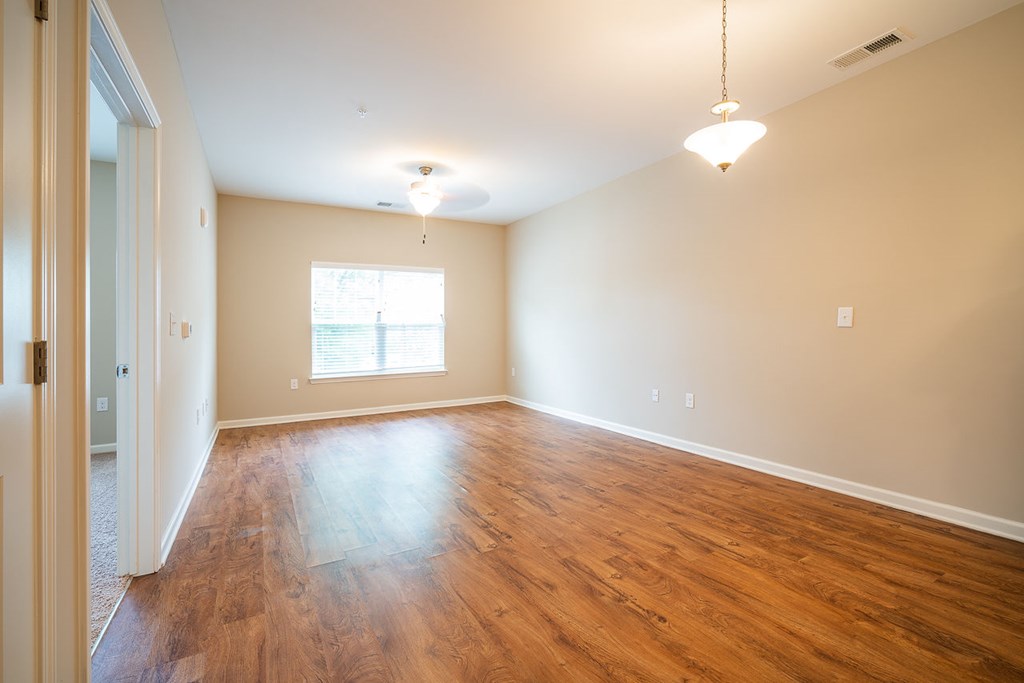 A room with wooden floors and a window.