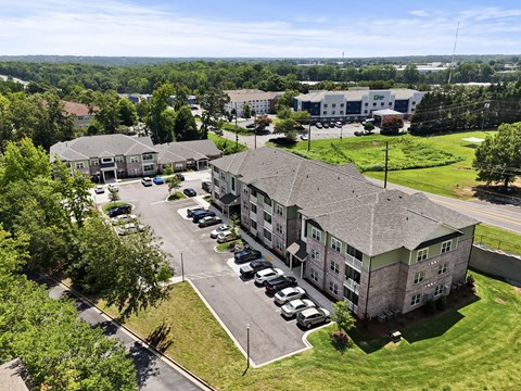 A large building with a parking lot in front of it.