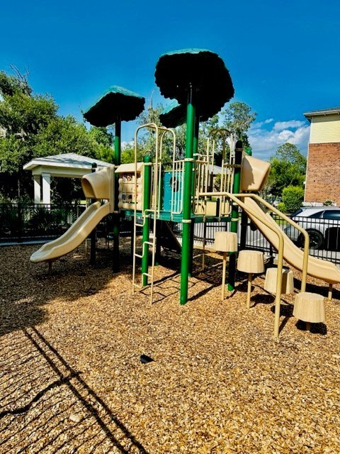 A playground with a slide and a climbing frame.