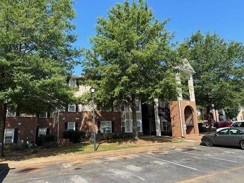 a parking lot in front of a brick building