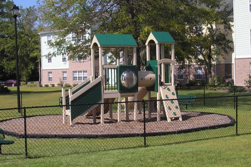 a playground with a slide and other playground equipment