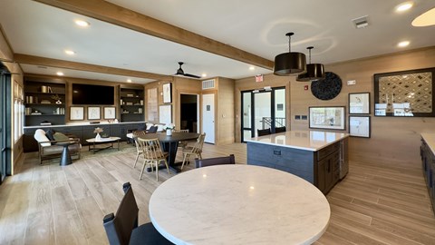 A modern kitchen with a dining table and chairs.