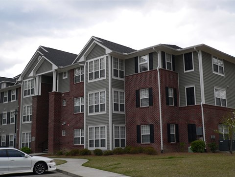 an apartment building with a car parked in front of it