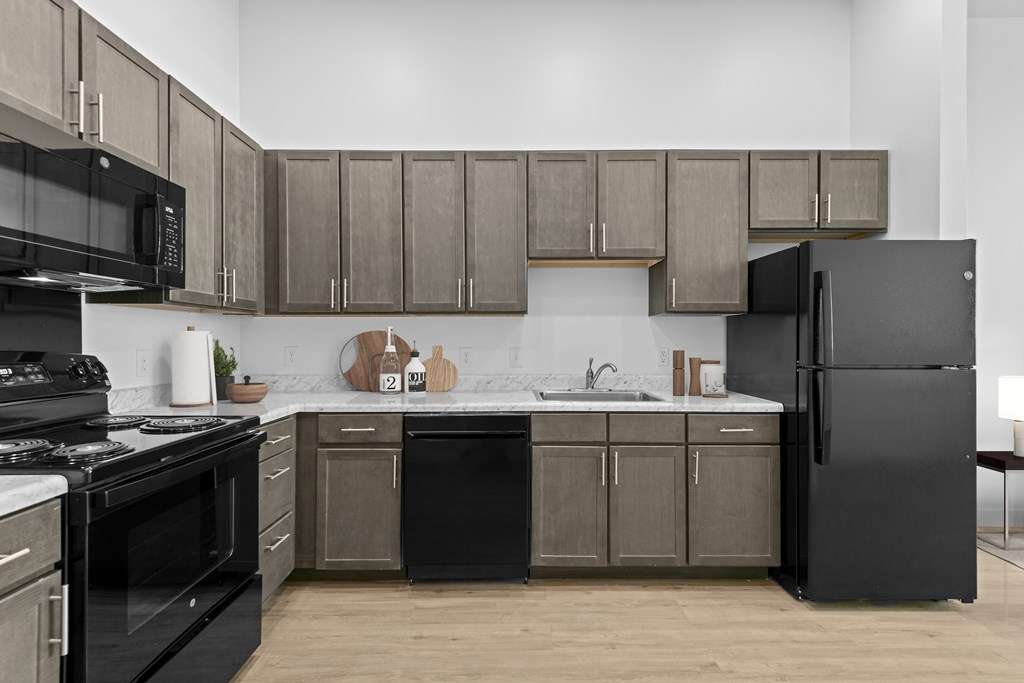 Modern kitchen with black appliances at 36N Apartments, Oklahoma, 74106