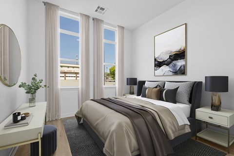 A bedroom with a large bed and a painting on the wall.