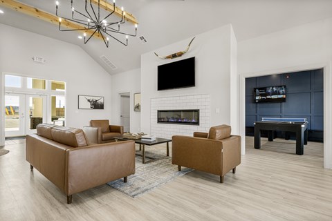 A modern living room with a pool table and a fireplace.