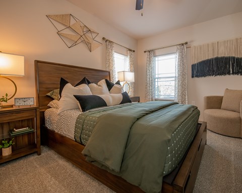 A bedroom with a large bed and a ceiling fan.