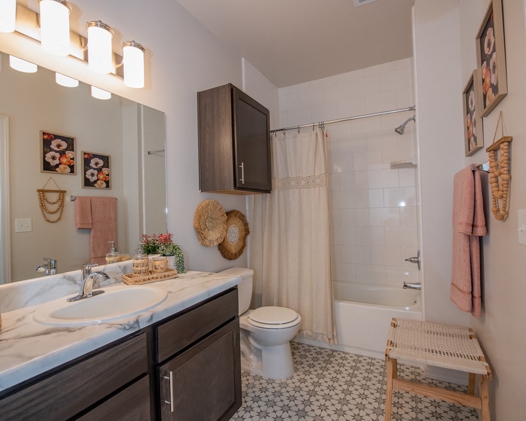 A bathroom with a white sink and a white toilet.