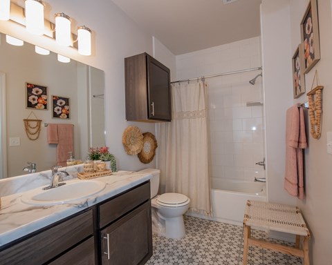 A bathroom with a white sink and a white toilet.