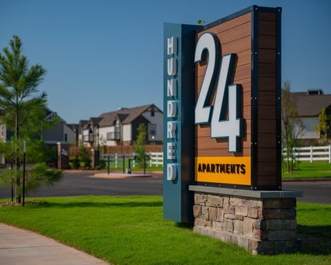 a sign for the 24 apartments on the side of a sidewalk