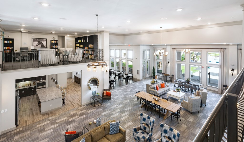 a view of a living room and dining room from the second floor