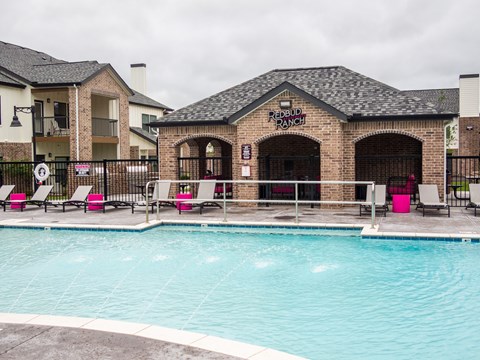 A pool area with a building that says Redbud Ranch.