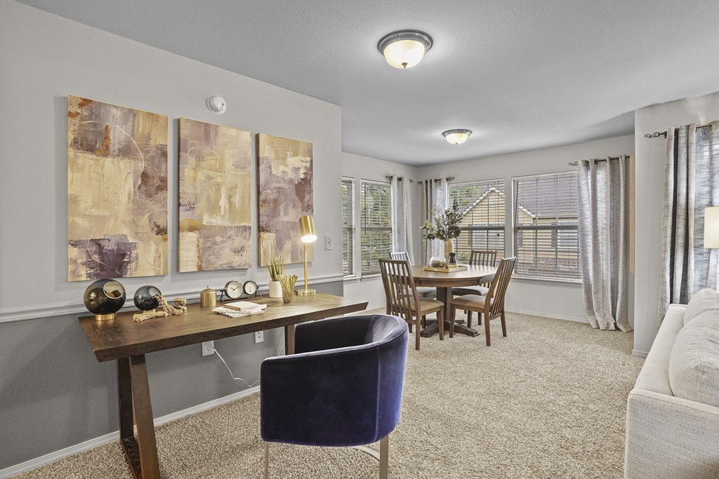 A living room with a dining table and chairs.