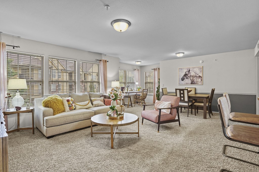 A living room with a couch, chairs, and a coffee table.