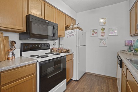 A kitchen with wooden cabinets and a white refrigerator.