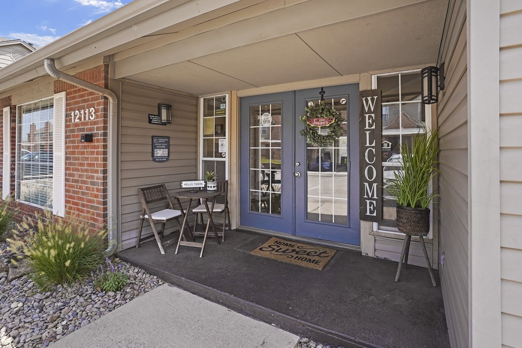 A welcoming entrance to a home with a glass door and a wreath on the door.
