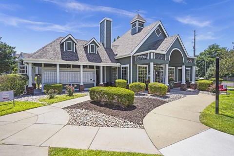 A large house with a grey roof and a white garage door.