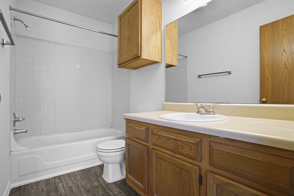 A white sink is on a countertop in a bathroom.