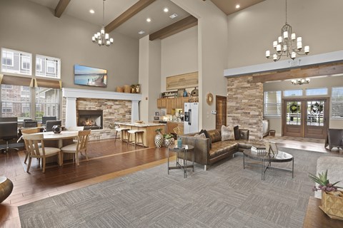 A large open living room with a fireplace and a dining table.