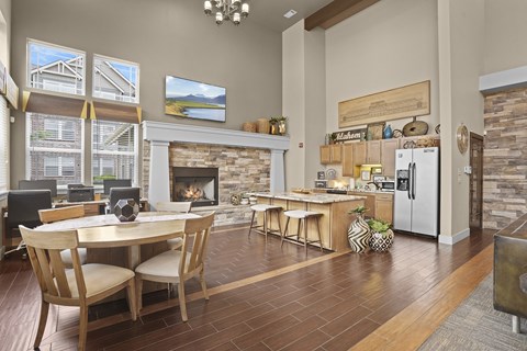 A modern kitchen with a dining table and chairs.