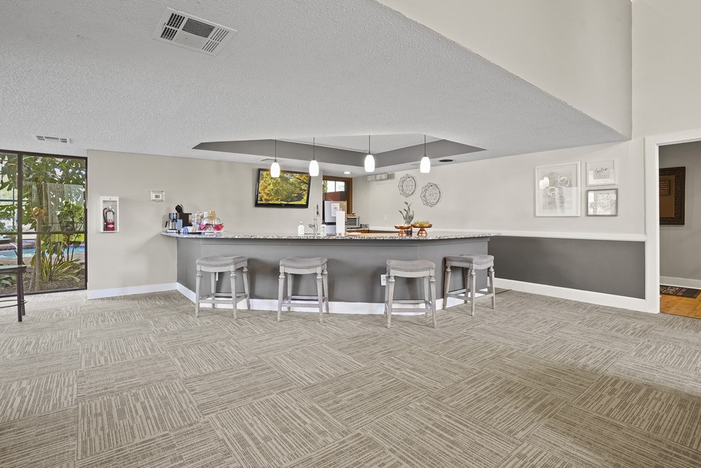A bar area with a counter and stools.