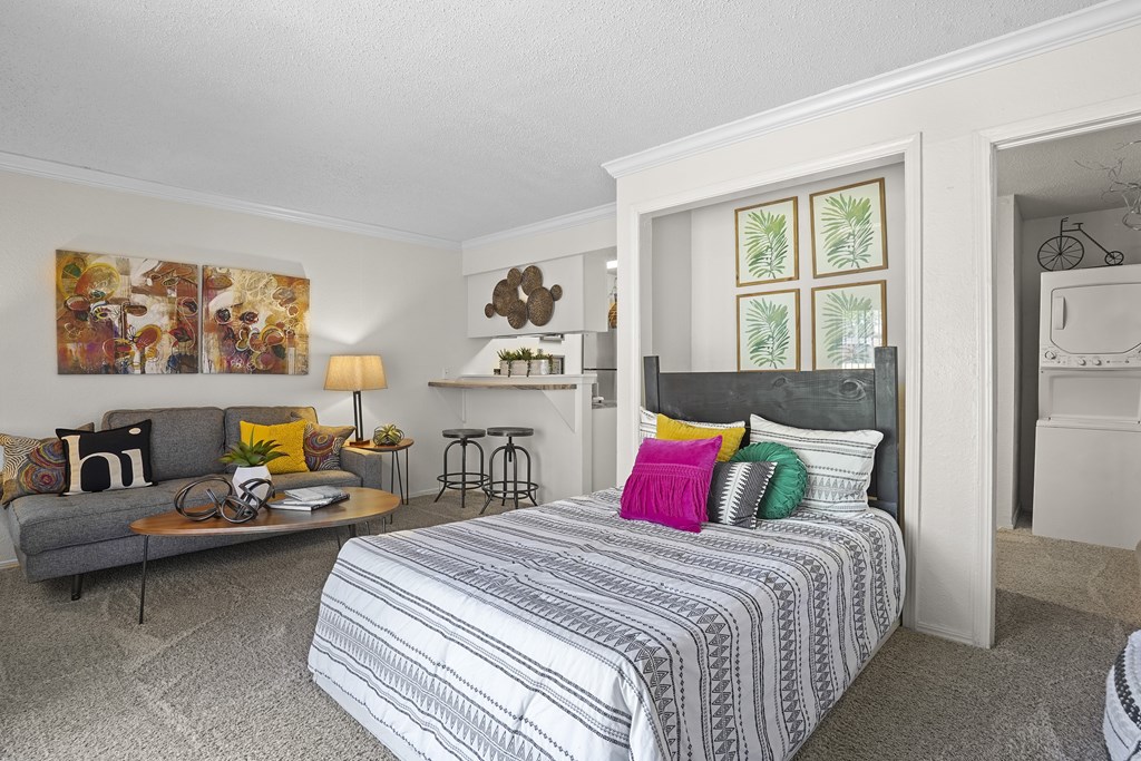 A bedroom with a large bed and a couch.