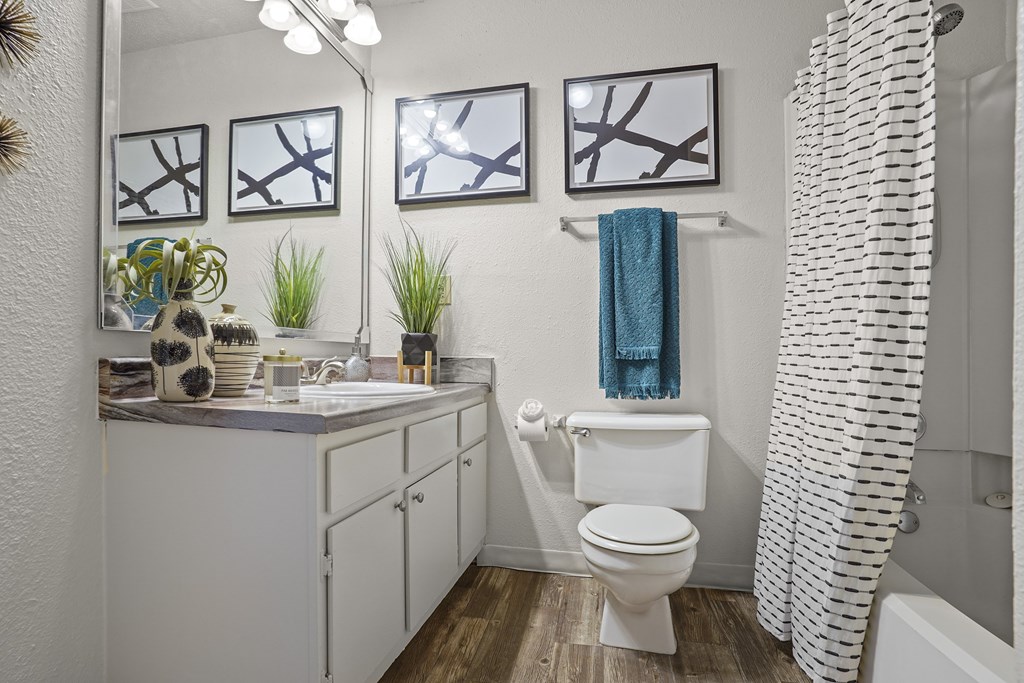 A white bathroom with a white toilet and a white sink.