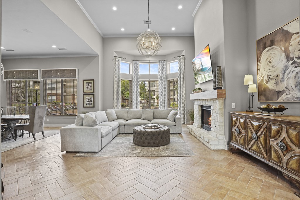 A living room with a fireplace and a large painting on the wall.