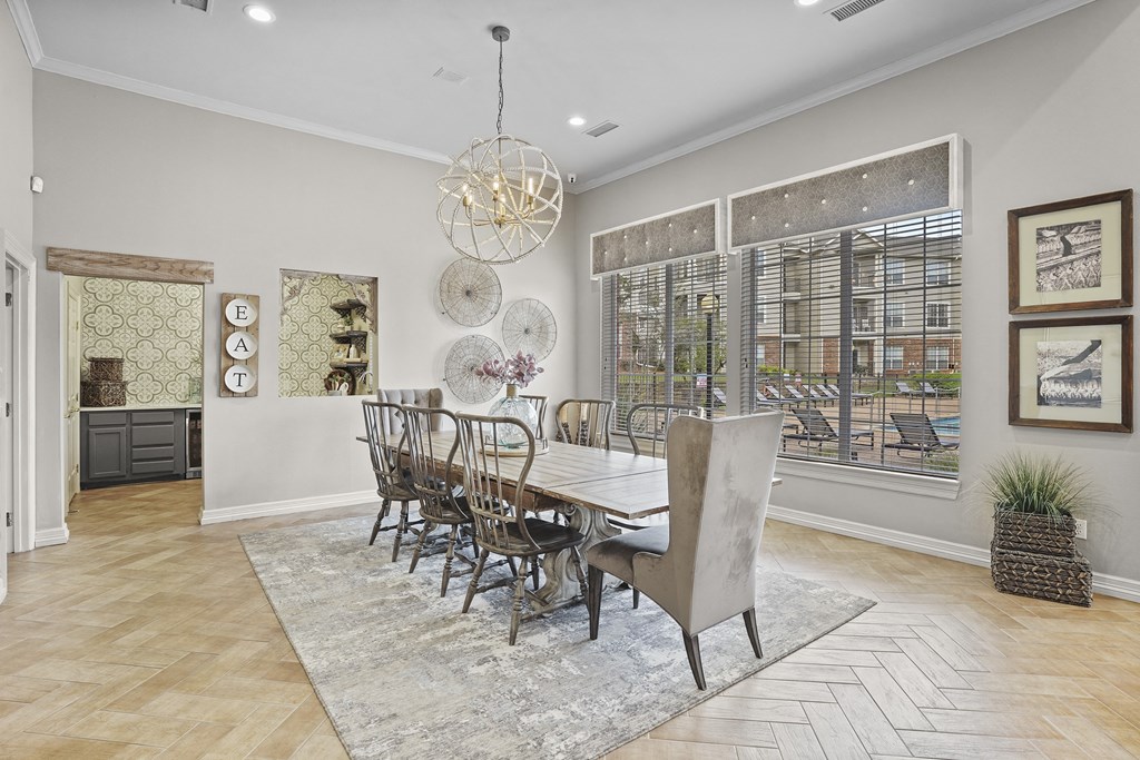 A dining room with a table set for six.