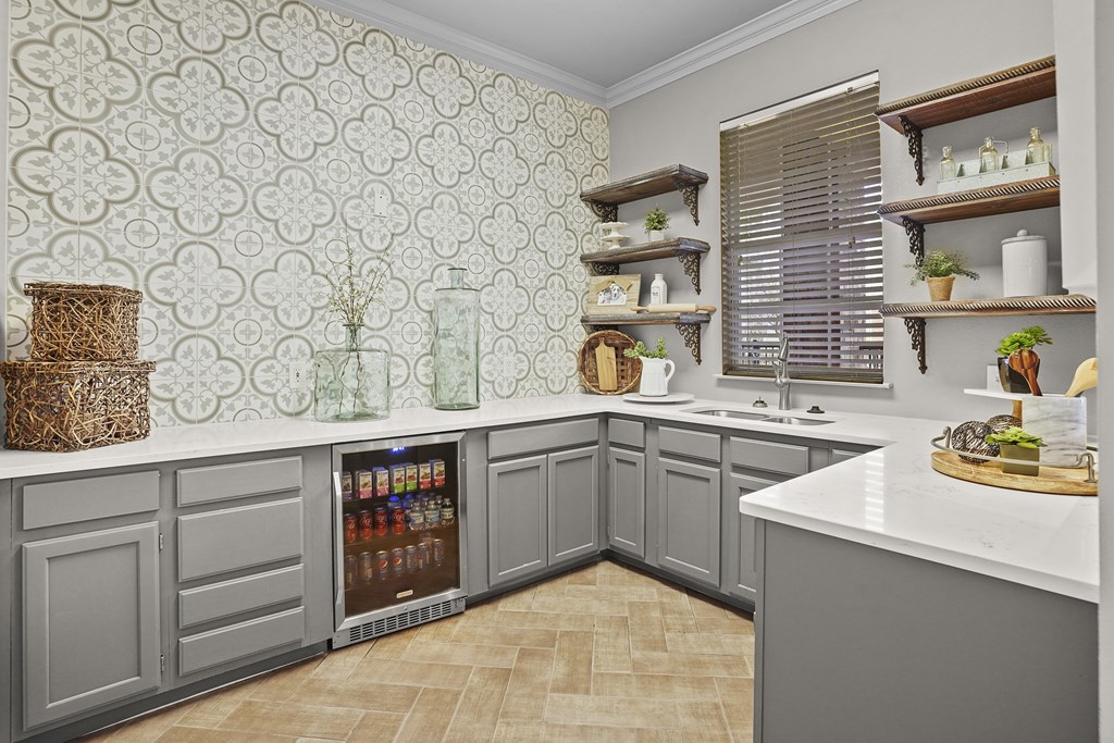 A kitchen with a patterned wallpaper and a refrigerator.