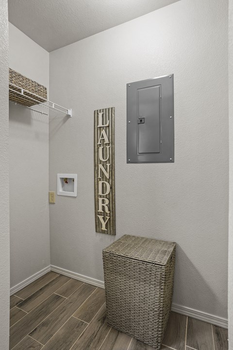 Laundry room with a basket and a sign.