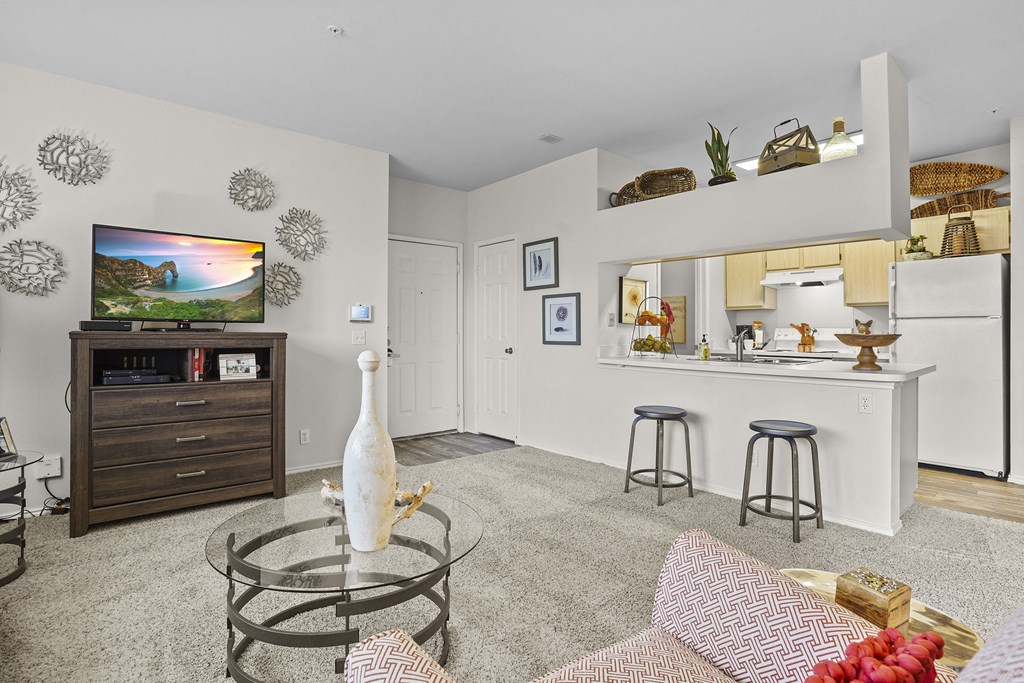 A living room with a TV, a bar, and a couch.