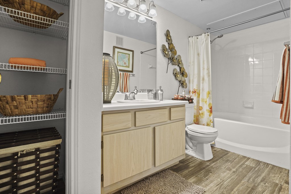 A bathroom with a white toilet, a white sink, and a white bathtub.