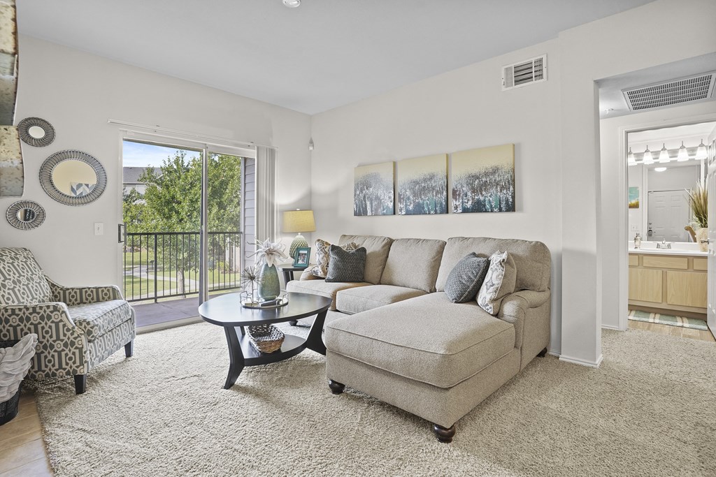 A living room with a sofa, chair, and a coffee table.