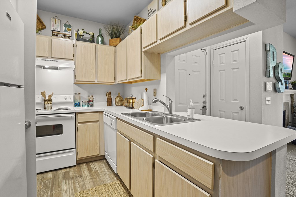 A kitchen with wooden cabinets and white appliances.