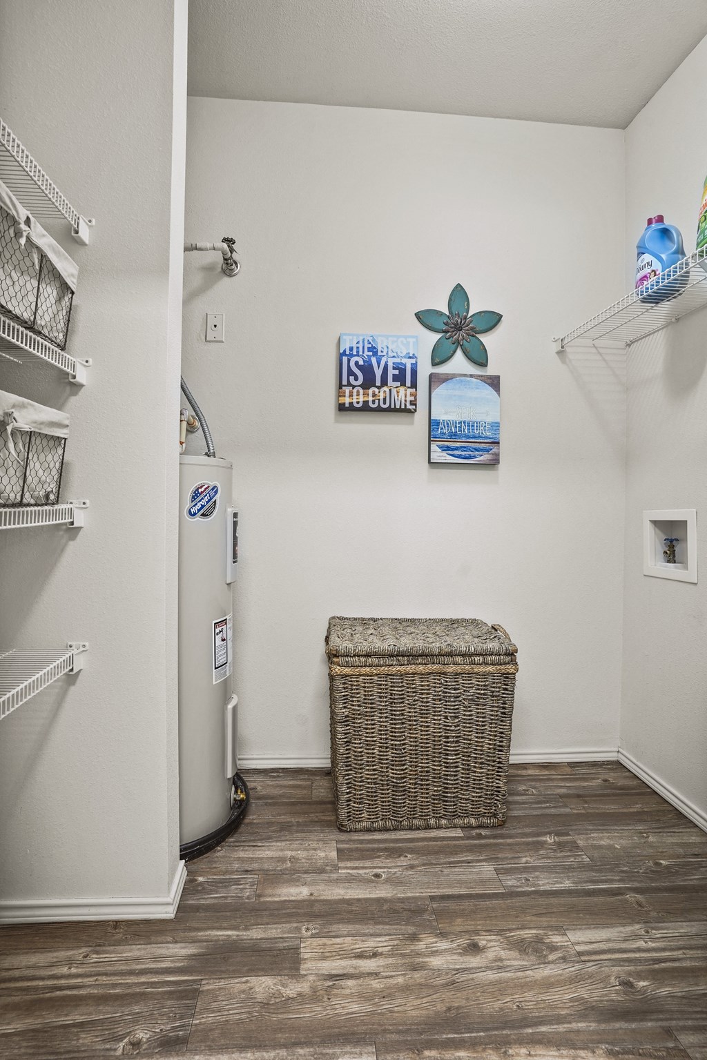 A room with a white wall and a basket on the floor.