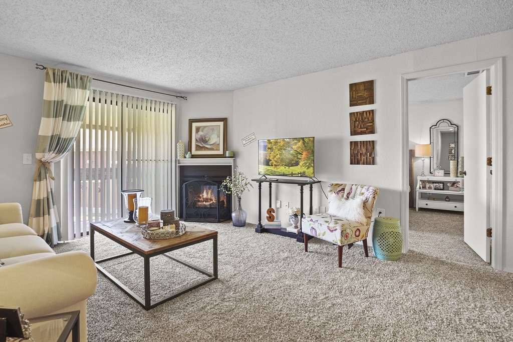 A living room with a fireplace and a chair.