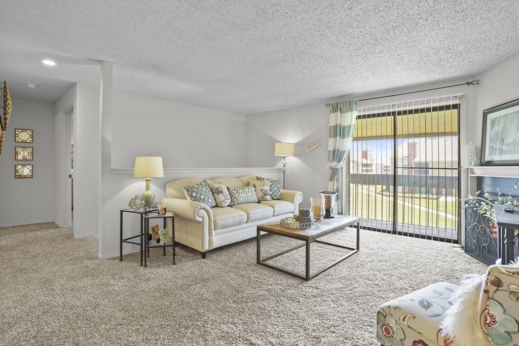 A living room with a white couch and a coffee table.