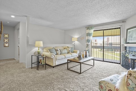 A living room with a white couch and a coffee table.