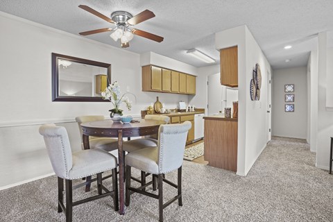 A dining room with a table and chairs.