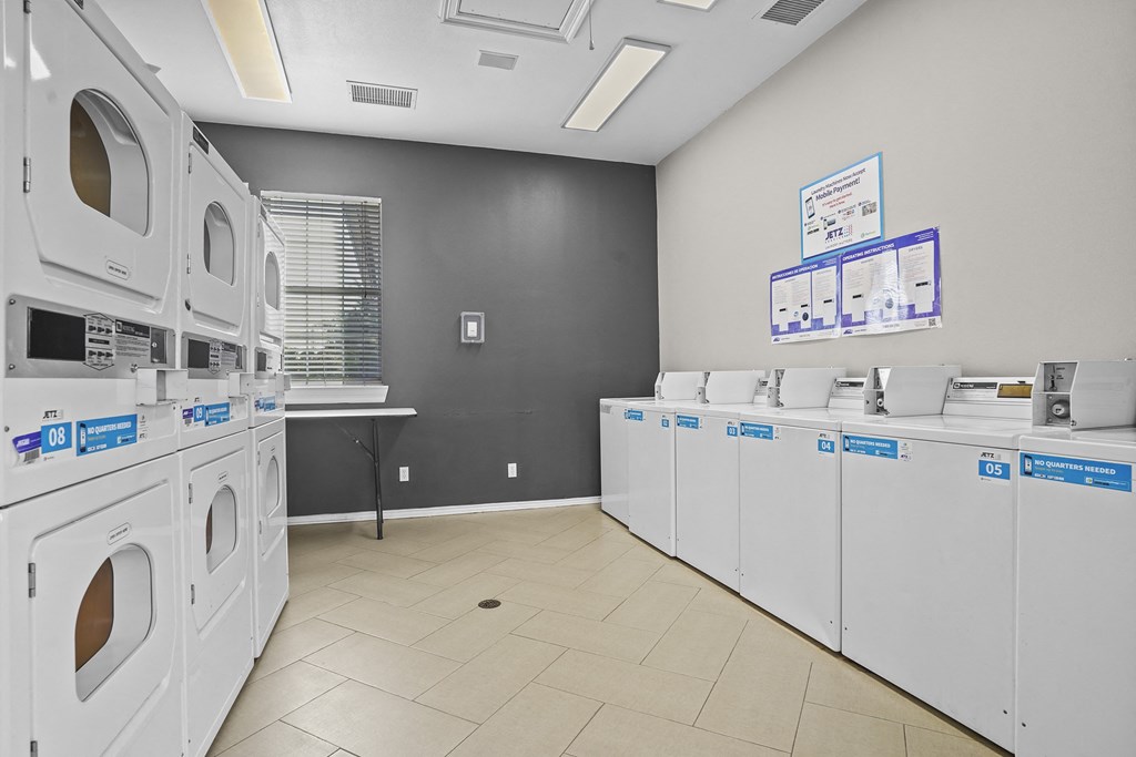 A laundry room with washers and dryers.