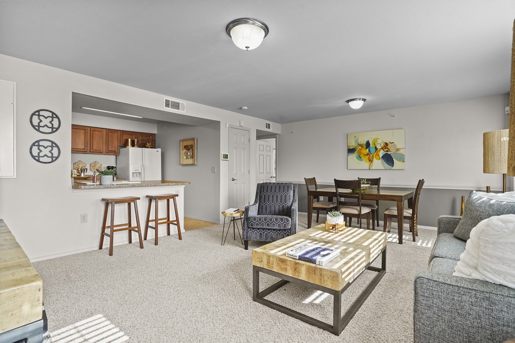A living room with a couch, chairs, and a coffee table.