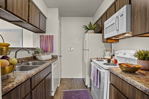 A kitchen with a white refrigerator and a white stove.